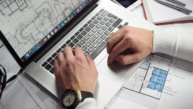 Reviewing component drawings and design on a laptop