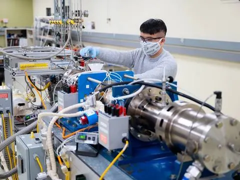Technician testing a part on machinery