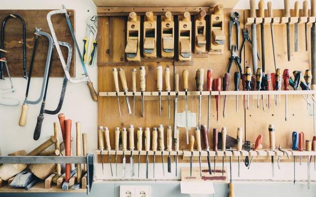 Hand tools neatly arranged on a workshop wall