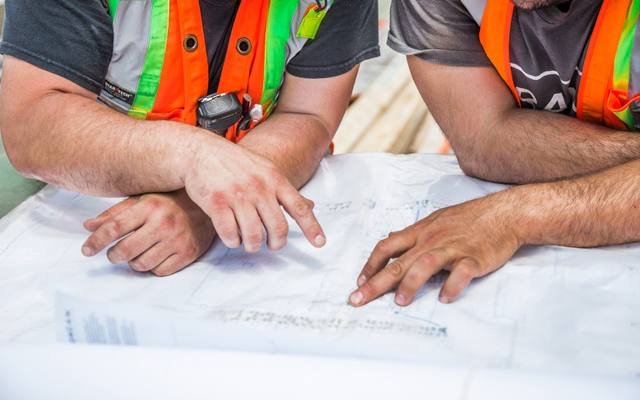 Two engineers reviewing drawings together