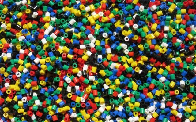Coloured plastic granules, consistent in size and shape